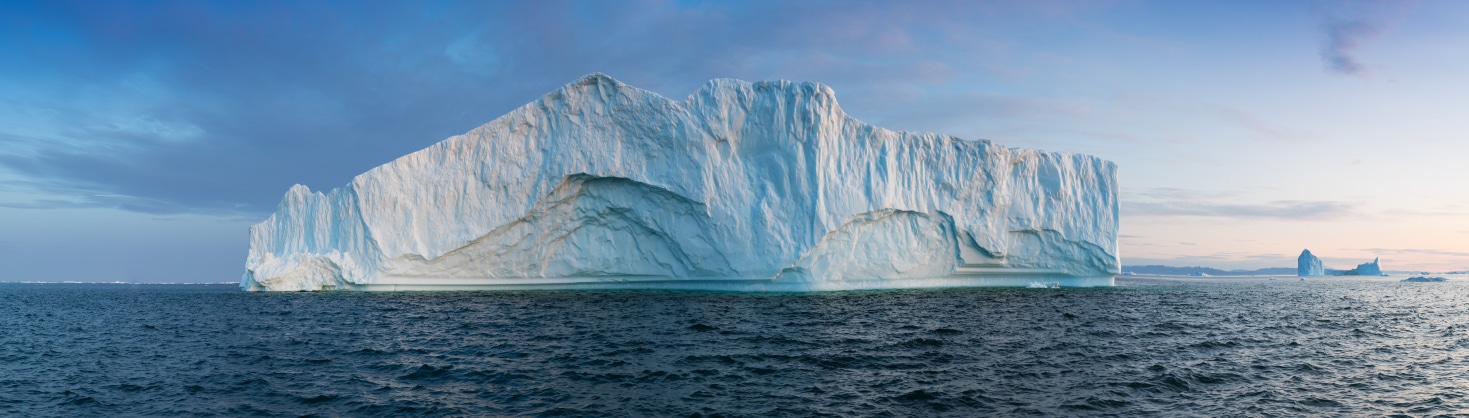A massive iceberg floating in the middle of the Artic Ocean